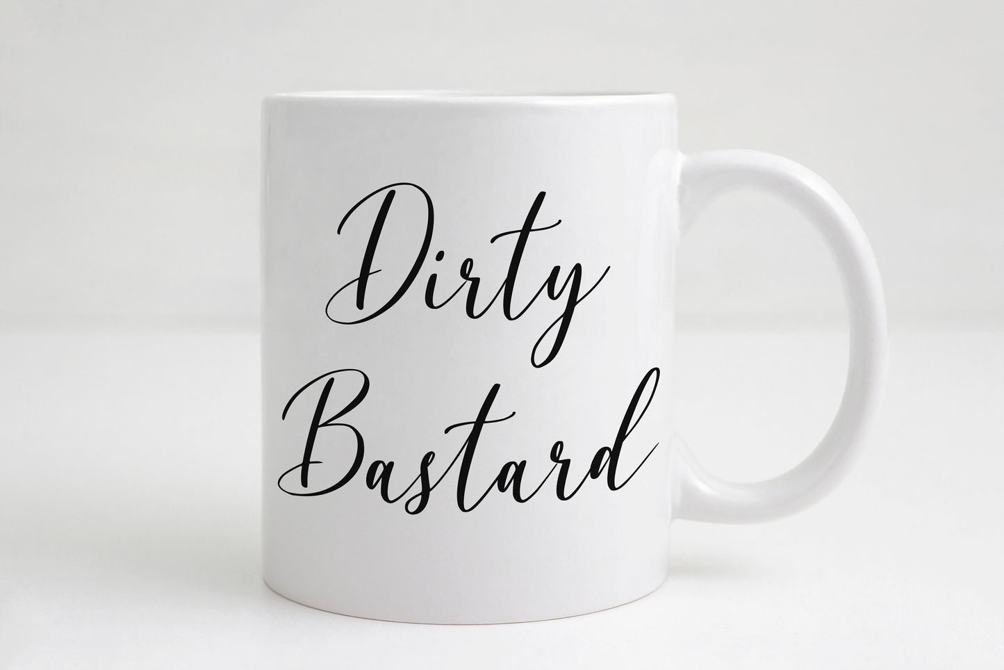 Dirty Bastard coffee mug with bold text on white ceramic