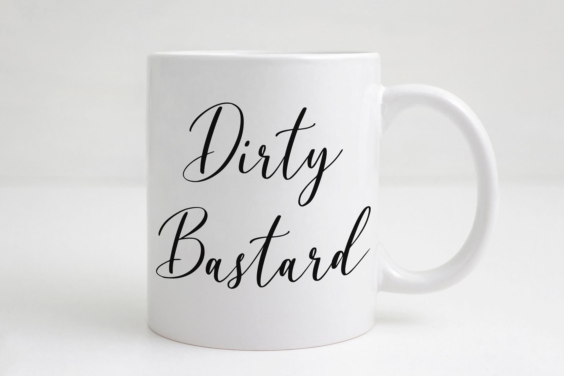 Dirty Bastard coffee mug with bold text on white ceramic
