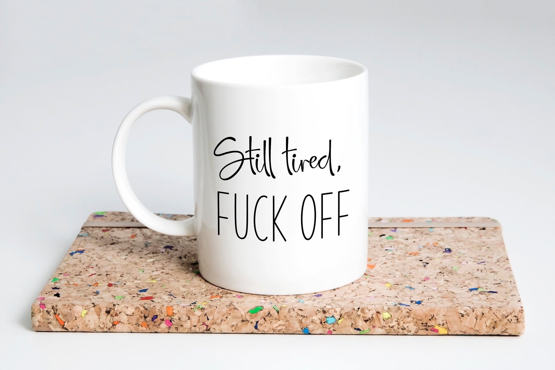 “Still Tired, F*ck Off coffee mug with bold text”
